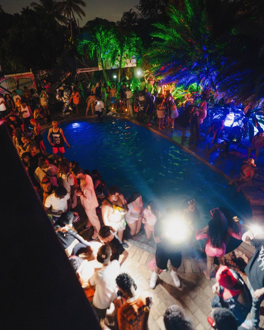 Night mansion pool party aerial view