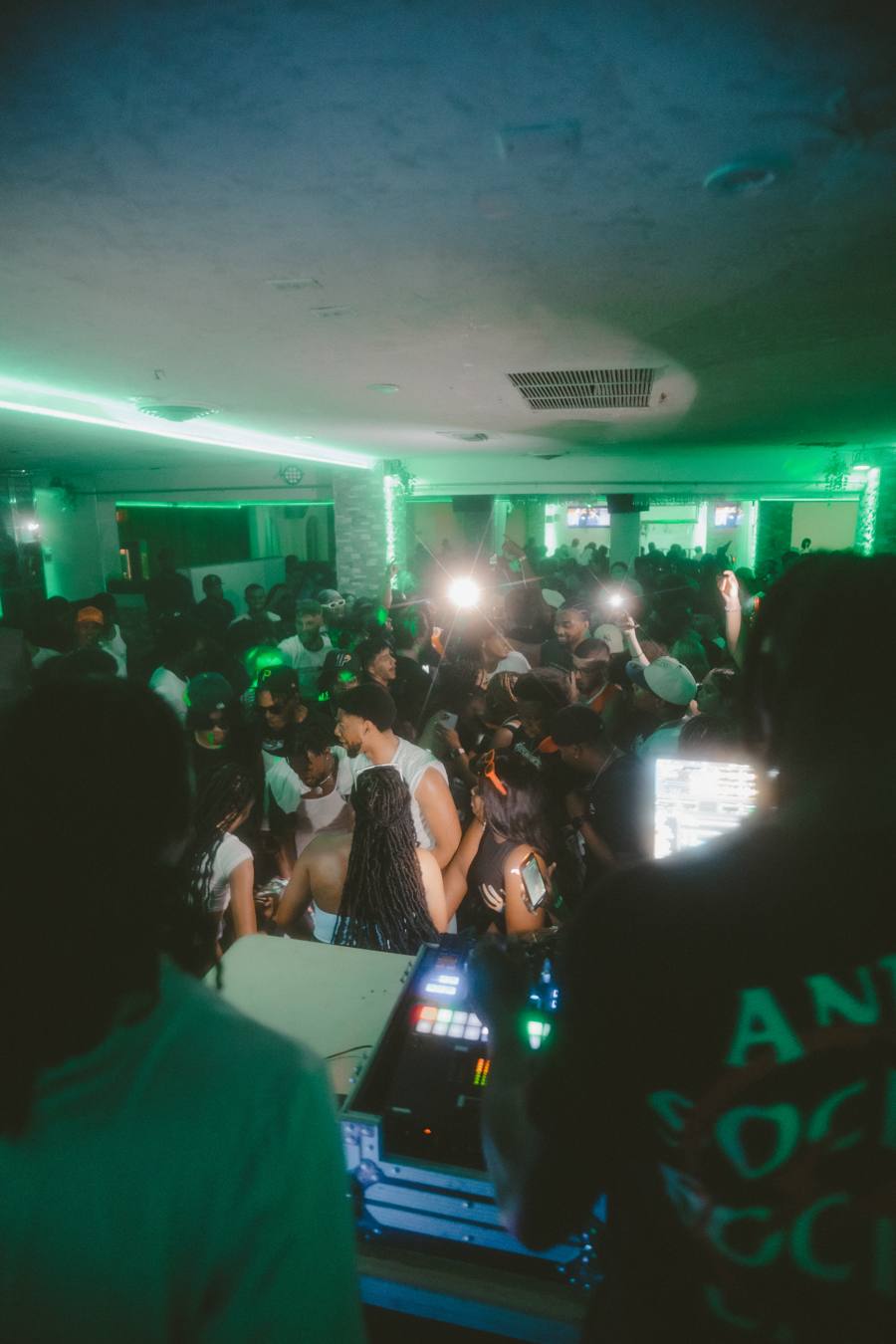 Green-lit ballroom crowd