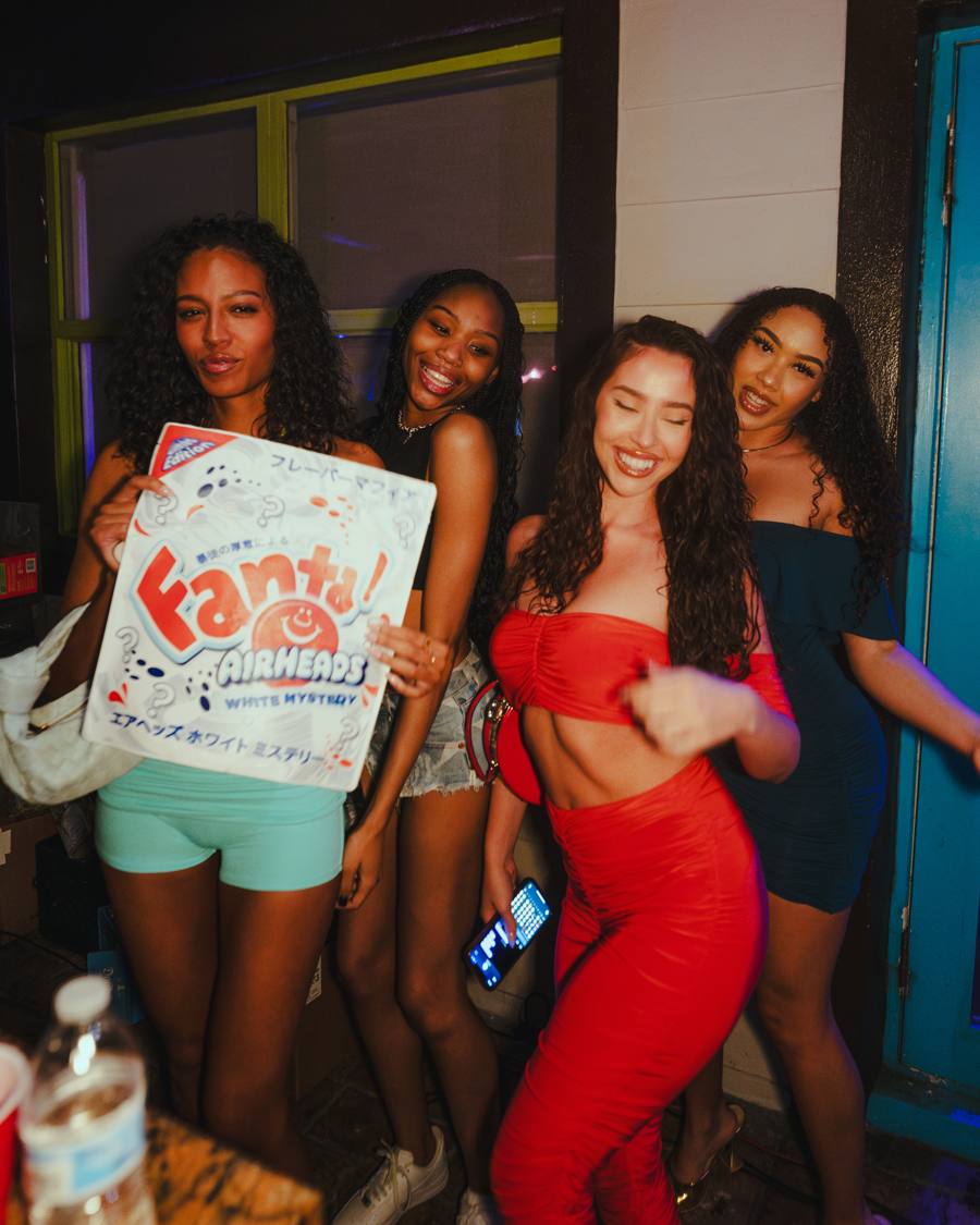 Friends with a party prop sign