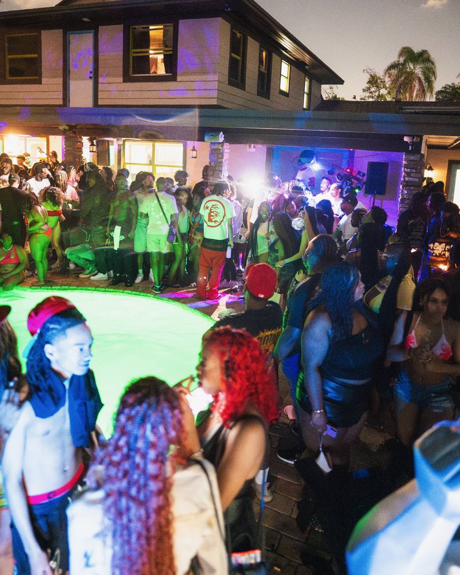Mansion backyard crowd at dusk