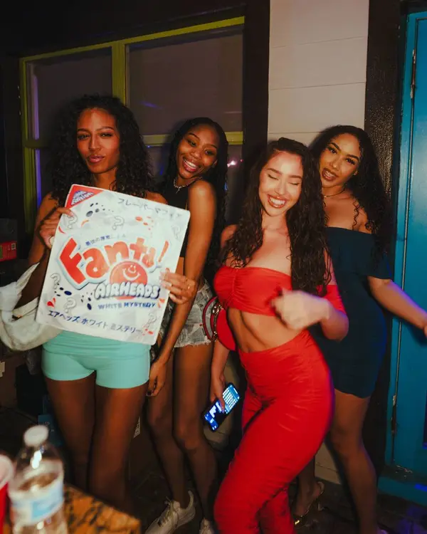 Friends with a party prop sign